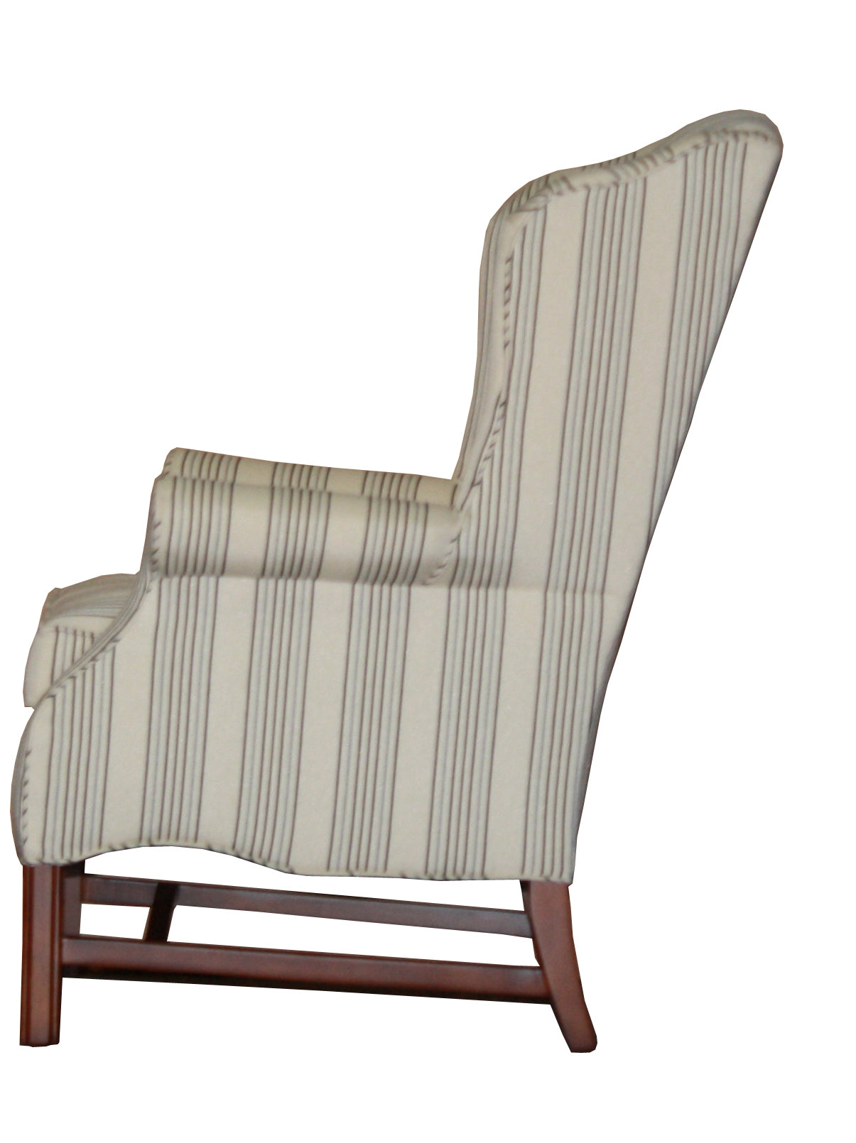 A carmel wingback chair in a light striped fabric, side view